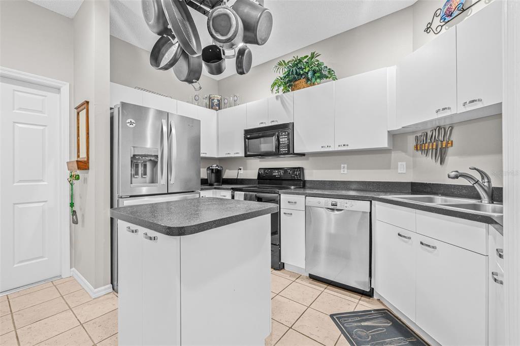 1050 Starkey Road, Unit 604 Largo, FL 33771 - Photo 9 of 28 a kitchen with stainless steel appliances granite countertop a sink and a stove