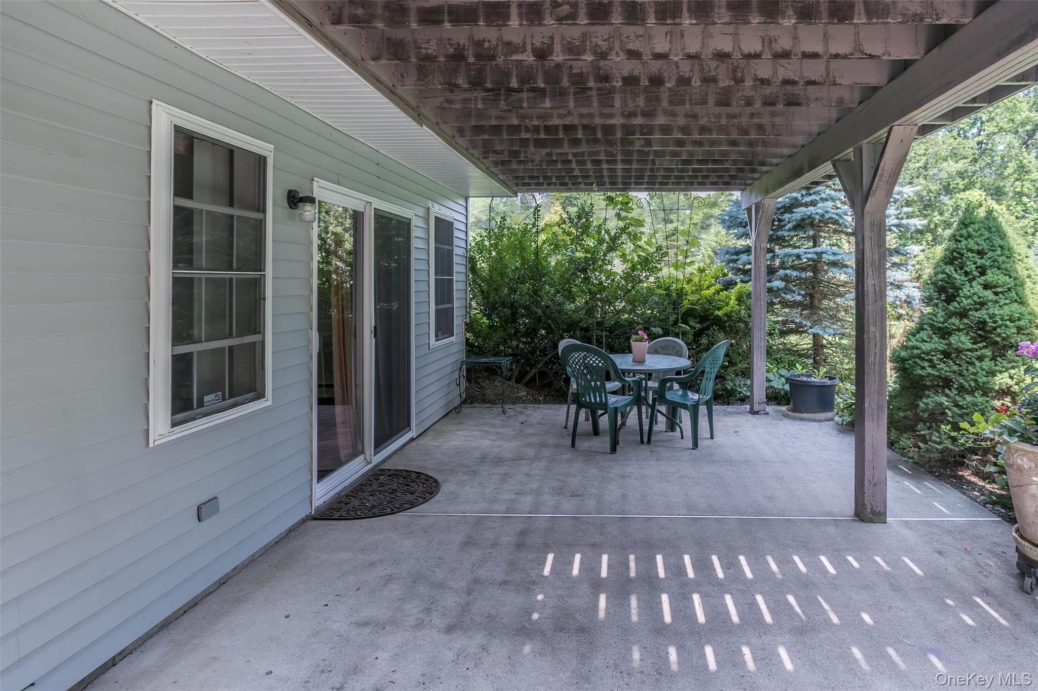 300 Mountain Lodge Road Monroe, NY 10950 - Photo 26 of 41 a view of a patio with table and chairs and potted plants