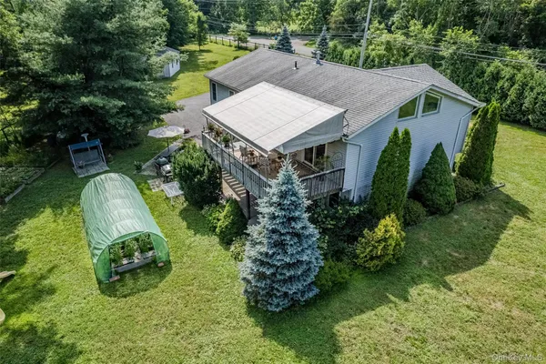 an aerial view of a house with a yard table and chairs