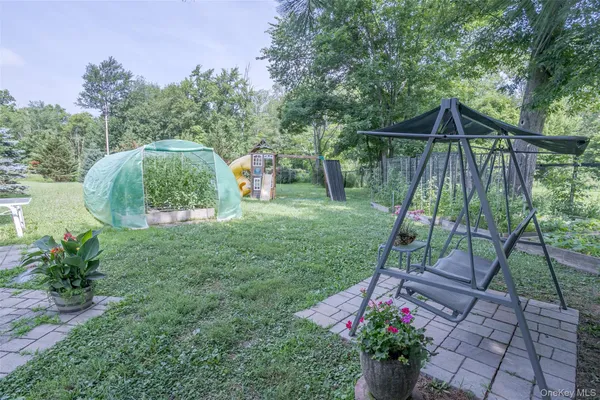 a backyard of a house with table and chairs