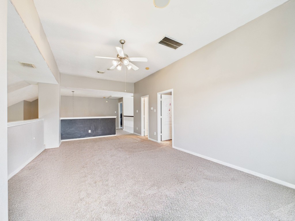 1484 Allison Street Alvin, TX 77511 - Photo 27 of 37 an empty room with a fireplace and fan