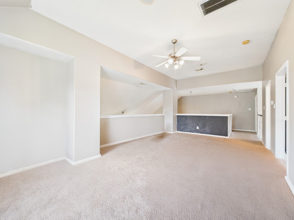 1484 Allison Street Alvin, TX 77511 - Photo 28 of 37 an empty room with a fireplace and a ceiling fan