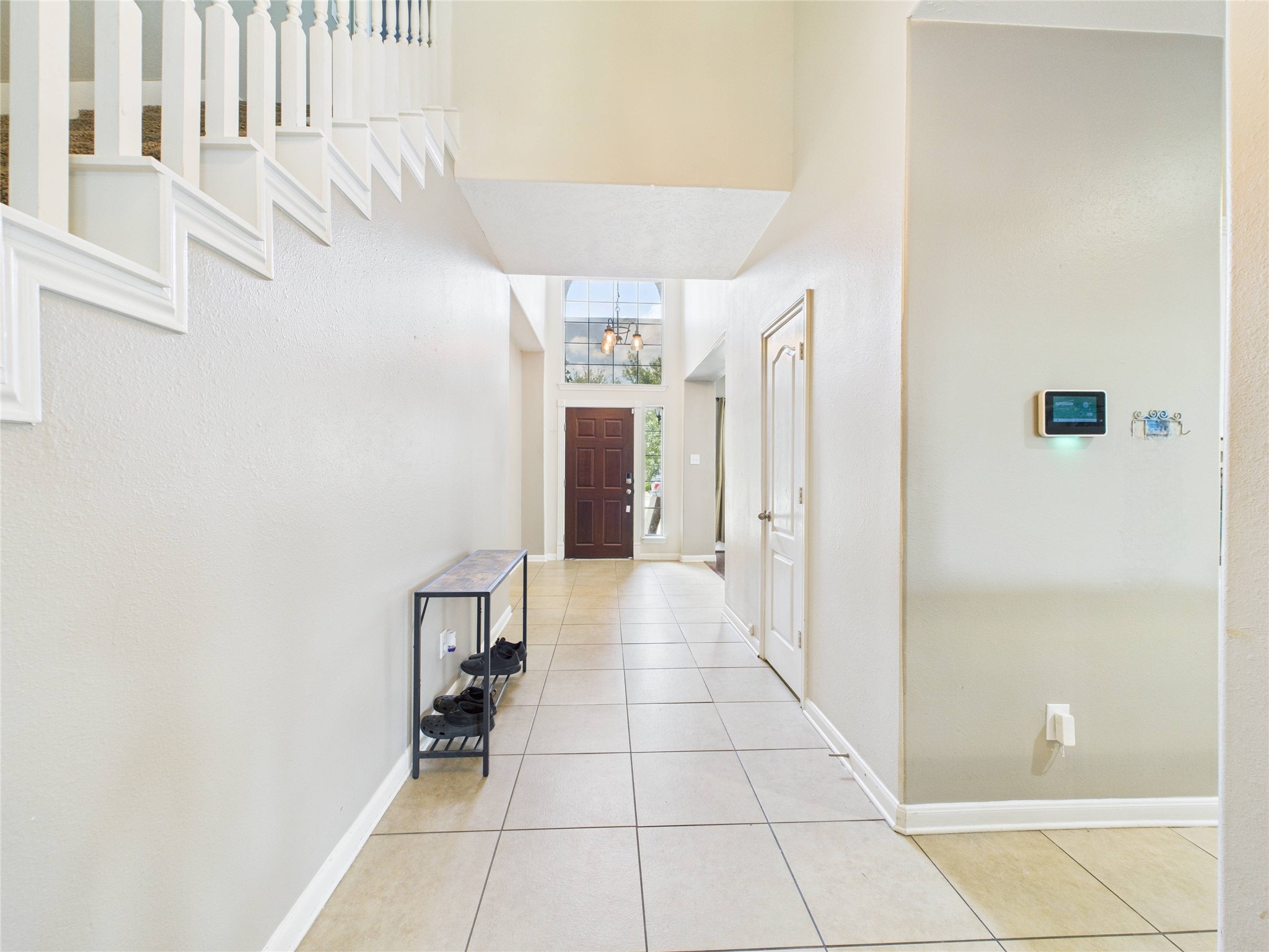 1484 Allison Street Alvin, TX 77511 - Photo 3 of 37 a hallway with a white cabinets and entryway