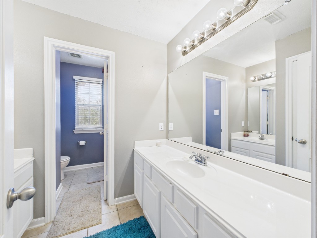 1484 Allison Street Alvin, TX 77511 - Photo 31 of 37 a bathroom with a sink and a mirror