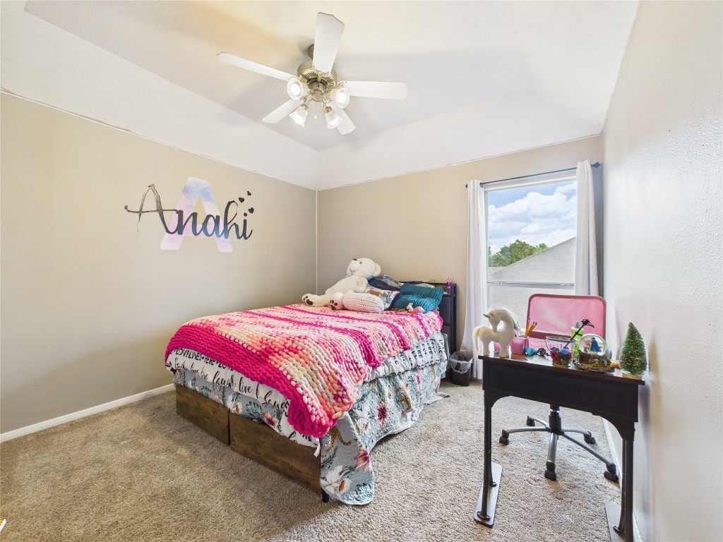 1484 Allison Street Alvin, TX 77511 - Photo 34 of 37 a bedroom with a bed and a chandelier