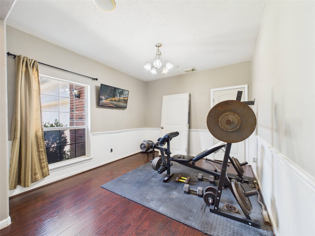 1484 Allison Street Alvin, TX 77511 - Photo 6 of 37 a view of a room with furniture wooden floor and a window