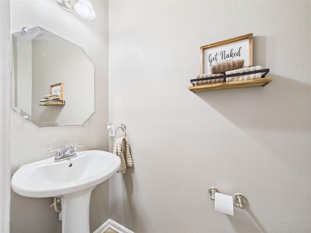 1484 Allison Street Alvin, TX 77511 - Photo 8 of 37 a bathroom with a sink mirror and vanity