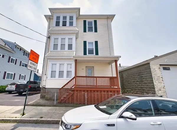 a front view of a house with parking space