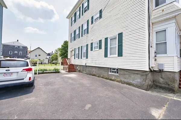 a view of a car park in front of a house