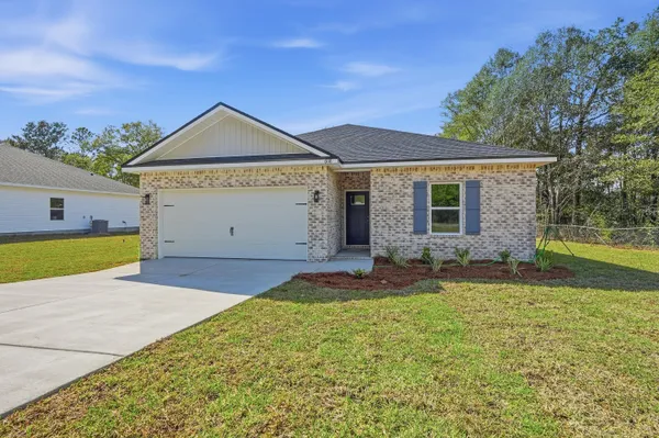 a view of an house with backyard space and tree