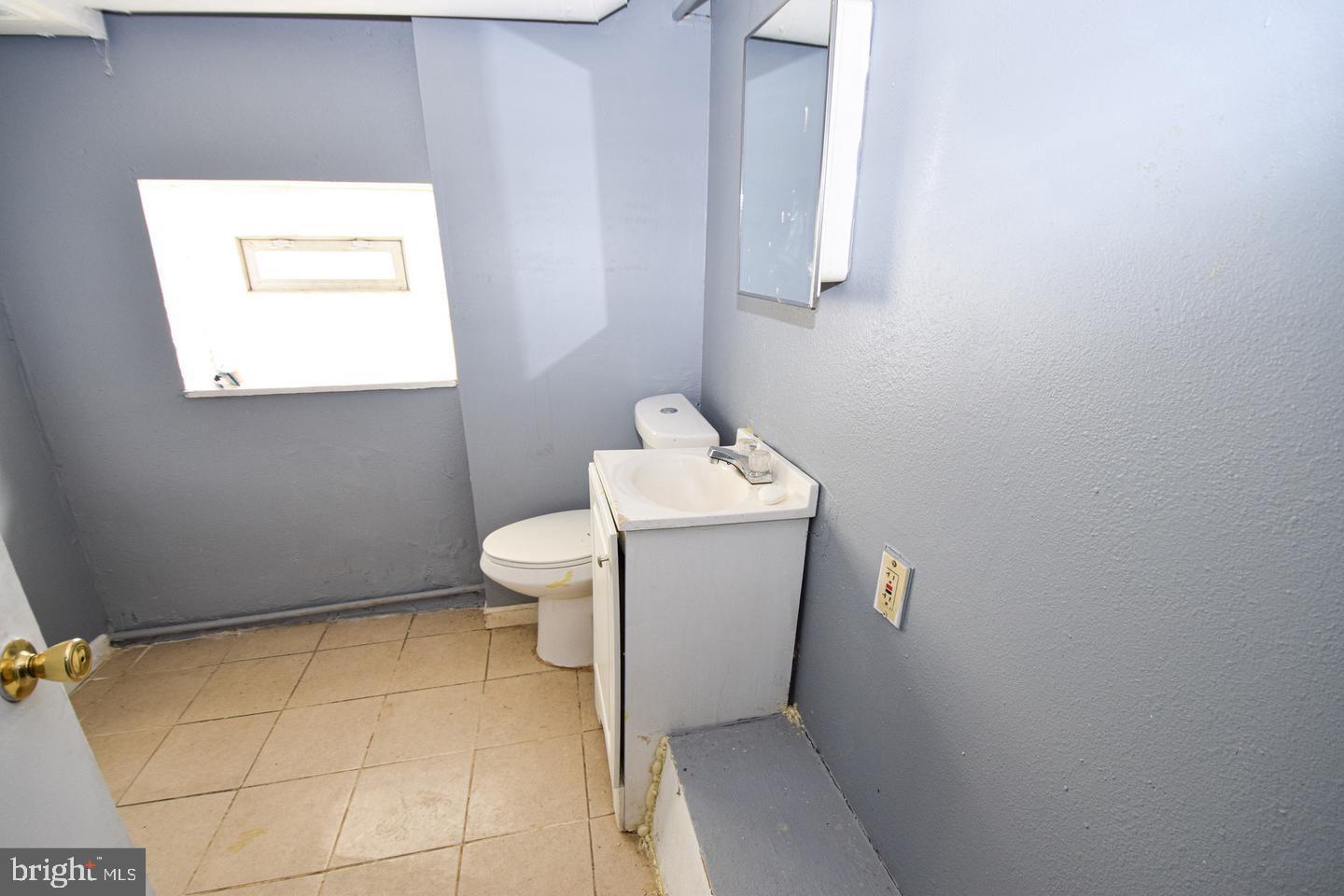 2101 West Baltimore Street Baltimore, MD 21223 - Photo 18 of 19 a bathroom with a toilet and sink