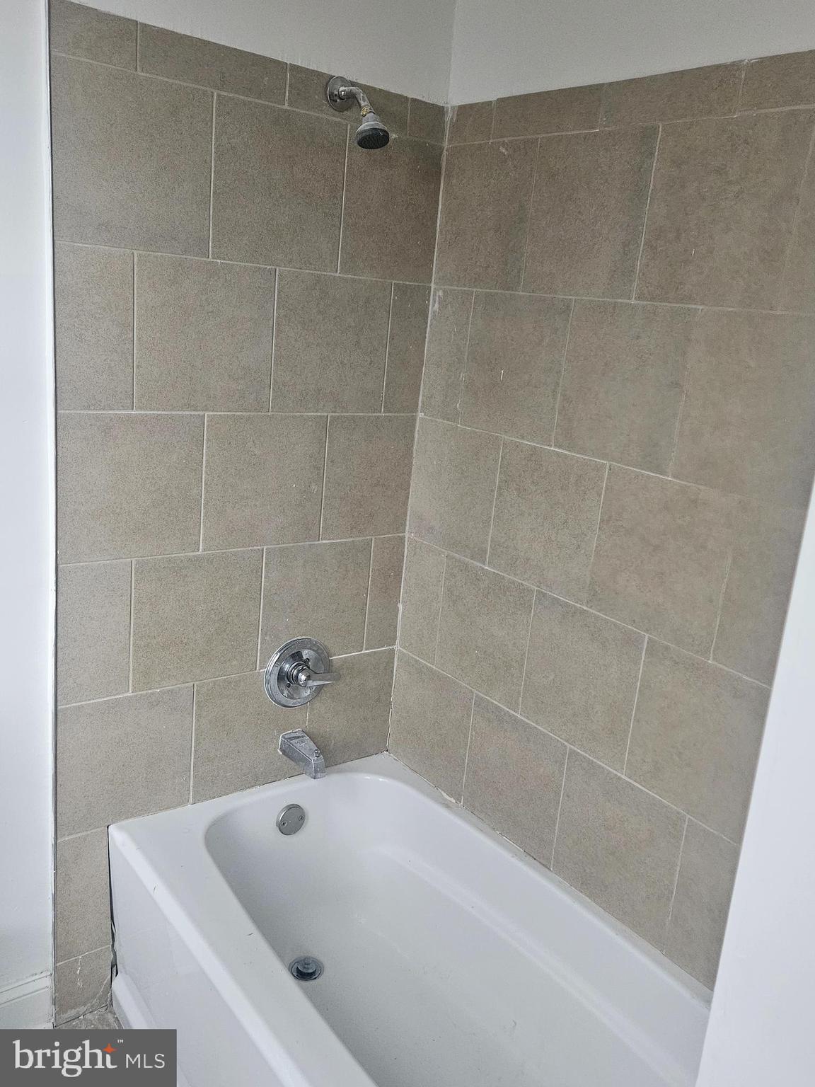 2101 West Baltimore Street Baltimore, MD 21223 - Photo 5 of 19 a bathroom with a white shower and a bathtub