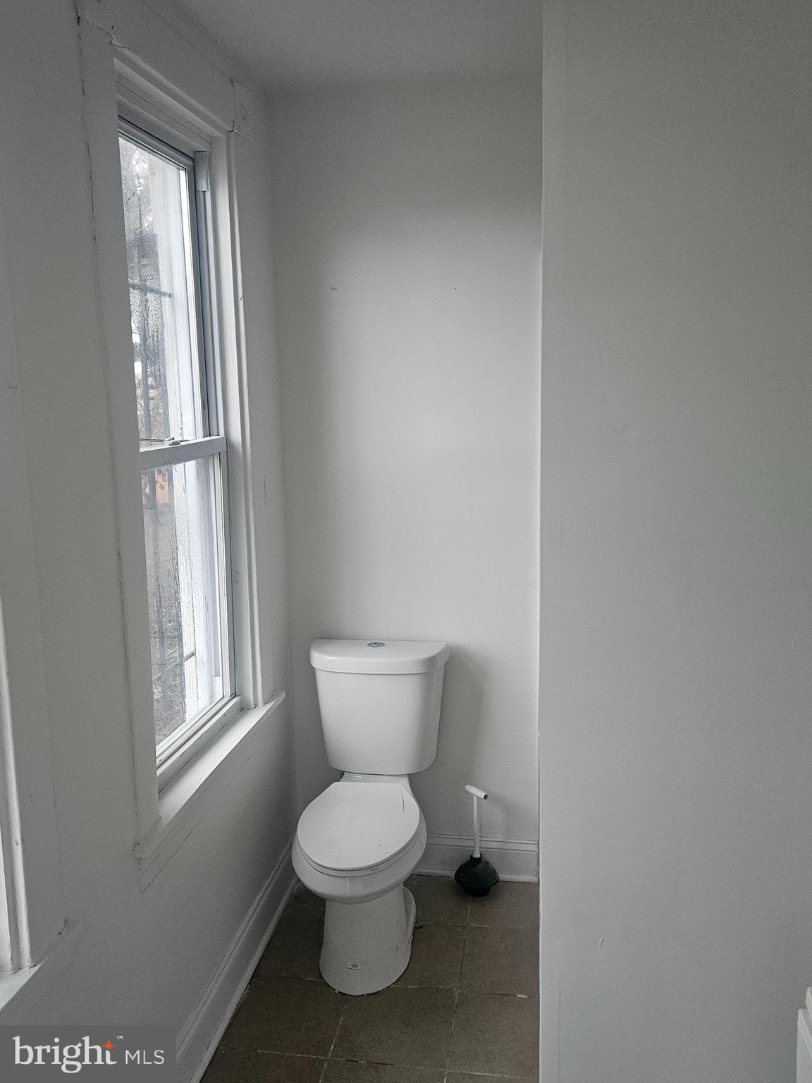 2101 West Baltimore Street Baltimore, MD 21223 - Photo 6 of 19 a white toilet sitting next to a window