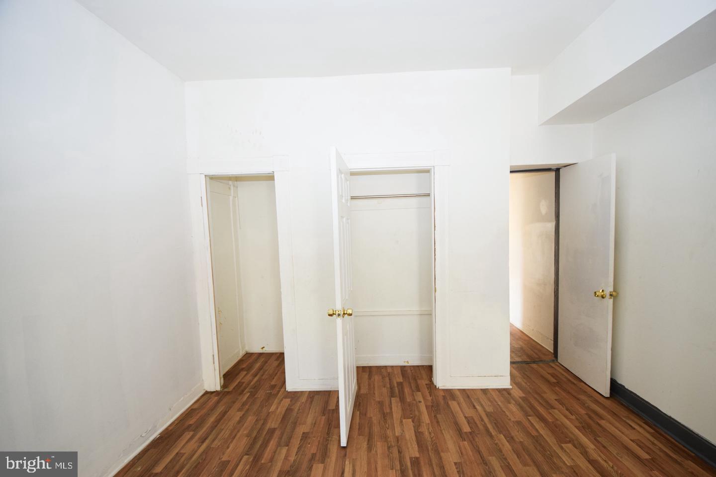 2101 West Baltimore Street Baltimore, MD 21223 - Photo 10 of 19 a view of a room with wooden floor and a hallway