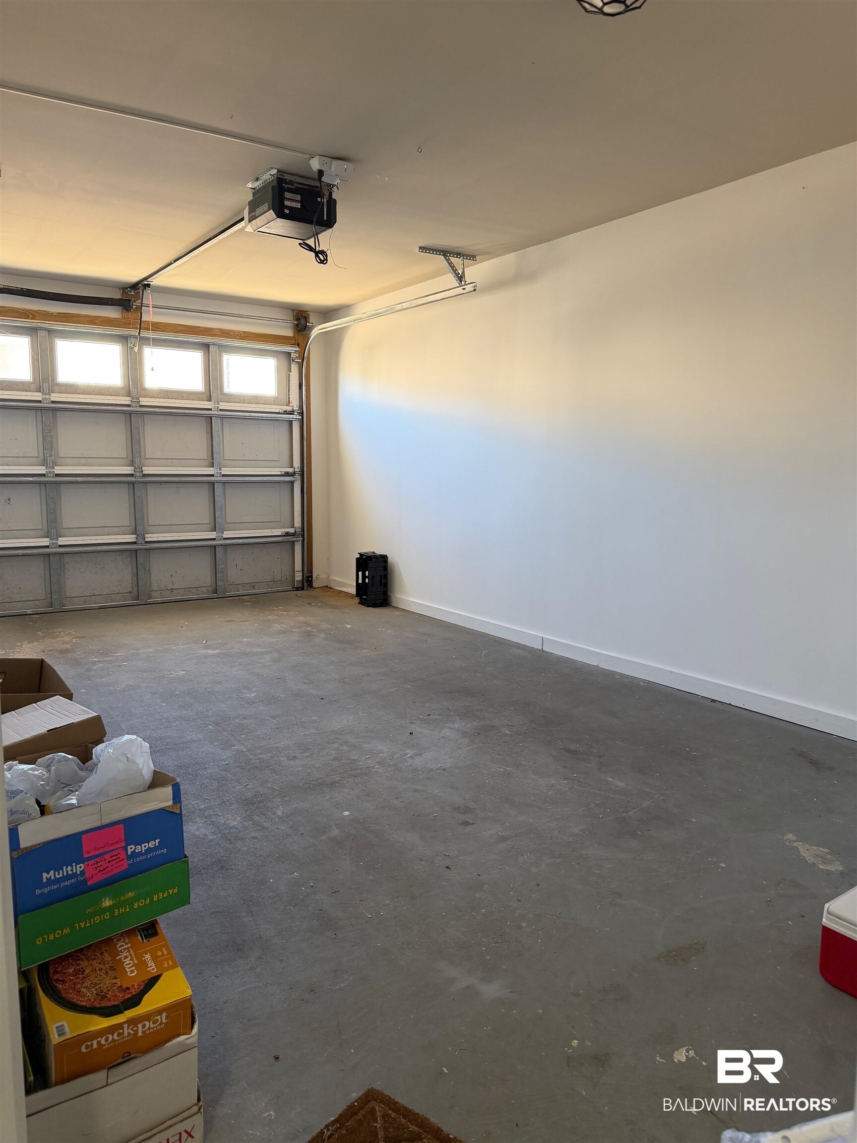 1517 Regency Road, Unit 71 Gulf Shores, AL 36542 - Photo 6 of 26 Garage with a garage door opener and baseboards