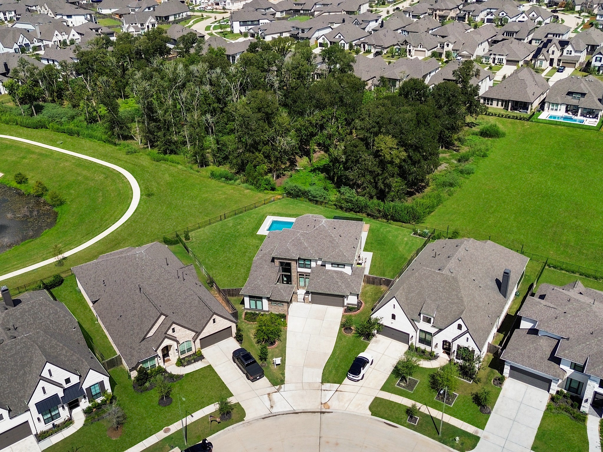 30214 Crossfield Road Fulshear, TX 77441 - Photo 41 of 42 This aerial perspective captures the approximately 0.39-acre homesite, private pool, and covered outdoor living in one view.