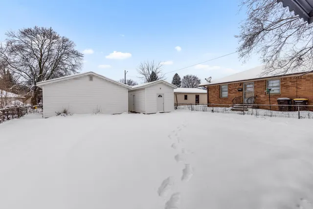 a view of a house with a yard and garage