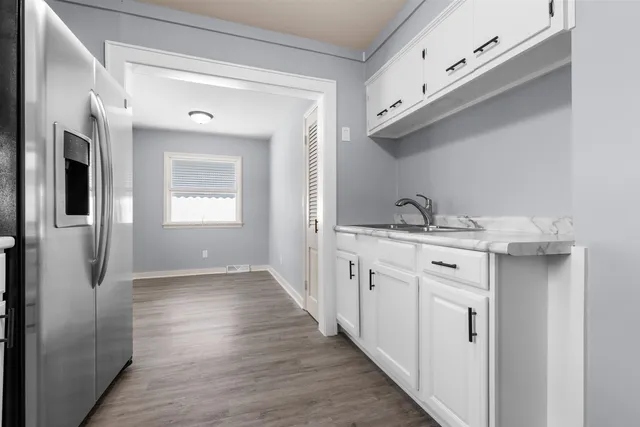 a kitchen with granite countertop a sink and cabinets