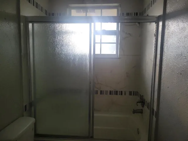 a view of a pathway of a wooden fence