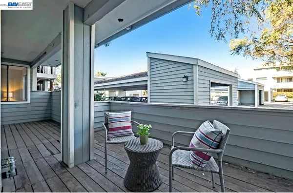 a view of a two chairs in the balcony