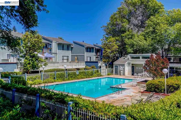 a view of a house with swimming pool and a yard