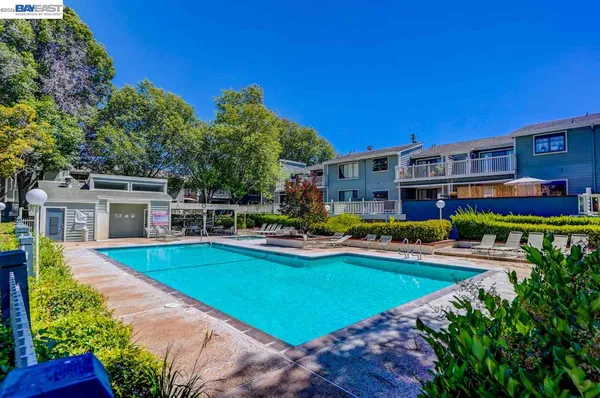 a view of a house with swimming pool yard and patio