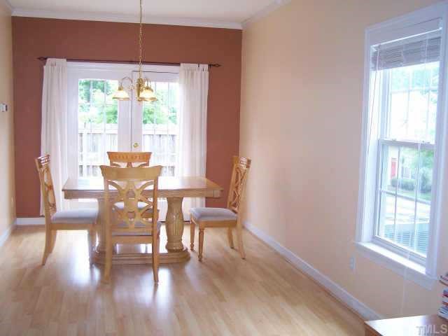 811 Rothshire Court, Unit 811 Raleigh, NC 27615 - Photo 3 of 7 a view of a dining room with furniture window and wooden floor
