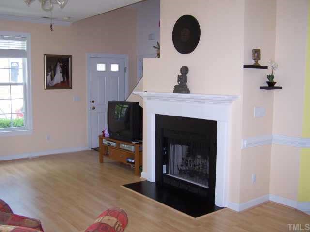 811 Rothshire Court, Unit 811 Raleigh, NC 27615 - Photo 4 of 7 a living room with furniture and a fireplace