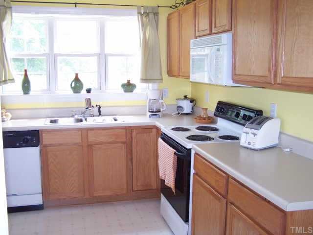 811 Rothshire Court, Unit 811 Raleigh, NC 27615 - Photo 5 of 7 a kitchen with stainless steel appliances granite countertop a sink stove and cabinets