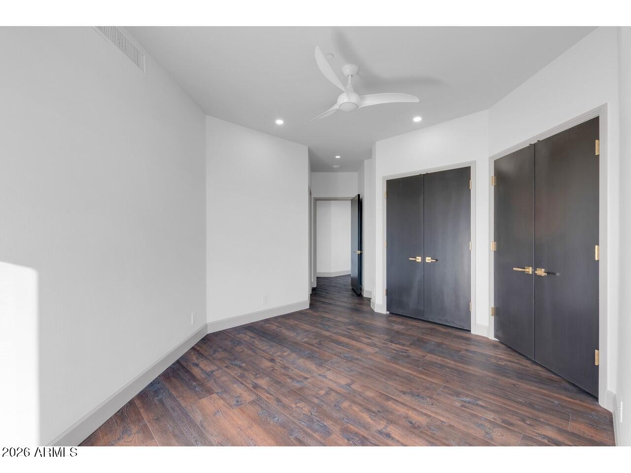 1040 East Osborn Road, Unit 1004 Phoenix, AZ 85014 - Photo 24 of 94 a view of an empty room with wooden floor