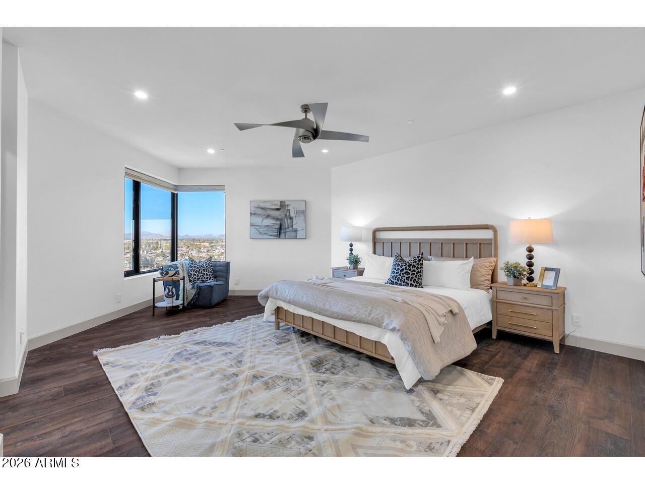 1040 East Osborn Road, Unit 1004 Phoenix, AZ 85014 - Photo 48 of 94 a spacious bedroom with a bed a couch and a chandelier