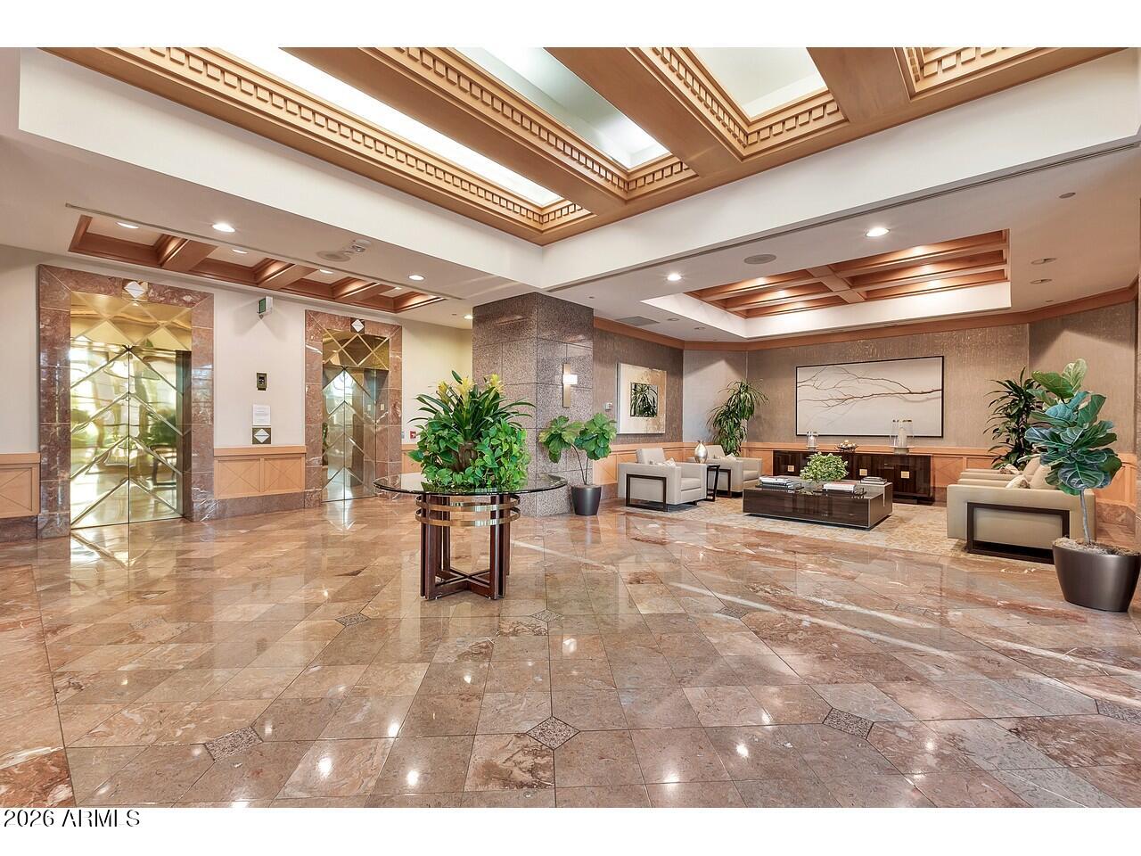 1040 East Osborn Road, Unit 1004 Phoenix, AZ 85014 - Photo 73 of 94 a view of a lobby with furniture and a potted plant