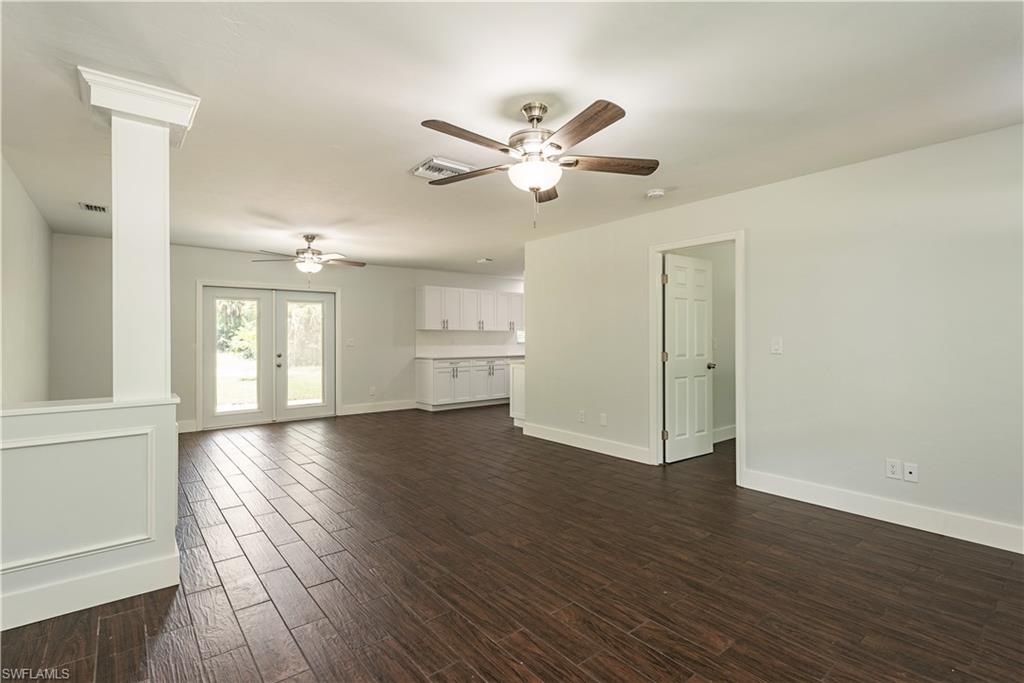 3831 31st Avenue Southwest Naples, FL 34117 - Photo 3 of 10 a view of an empty room with wooden floor and a window