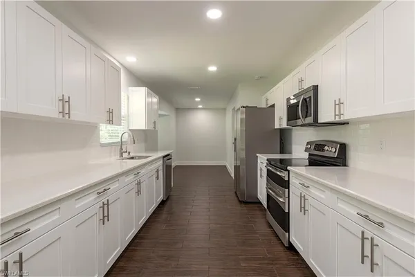 a kitchen with cabinets and stainless steel appliances