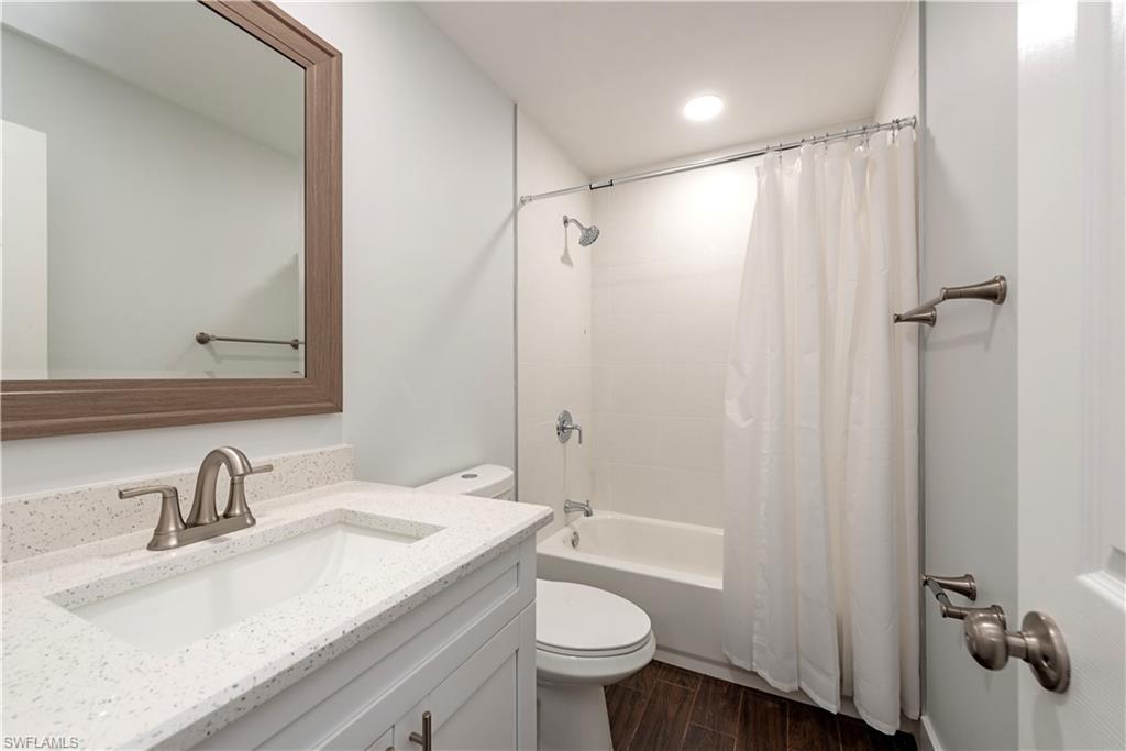3831 31st Avenue Southwest Naples, FL 34117 - Photo 7 of 10 a bathroom with a granite countertop sink toilet and shower