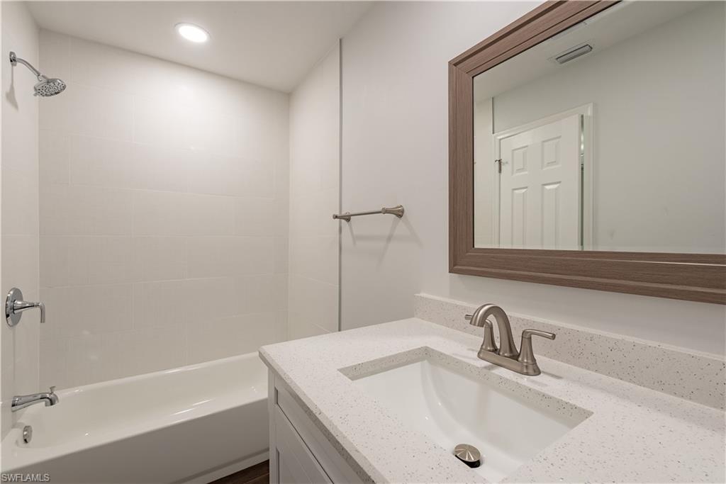 3831 31st Avenue Southwest Naples, FL 34117 - Photo 9 of 10 a bathroom with a sink and a mirror