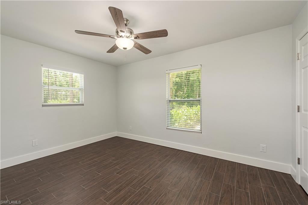 3831 31st Avenue Southwest Naples, FL 34117 - Photo 10 of 10 a view of an empty room with wooden floor and a window