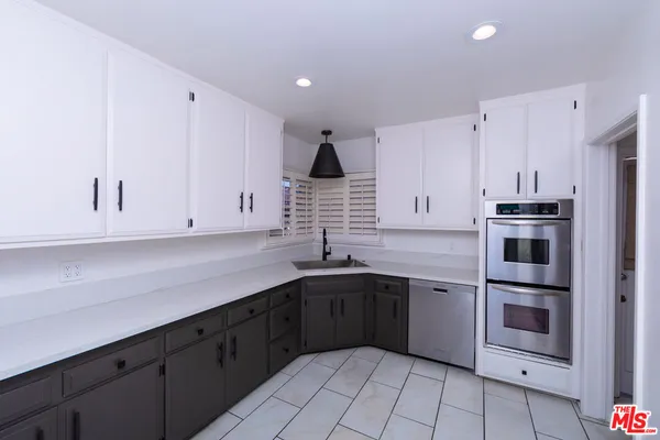 a kitchen with a sink stove and cabinets