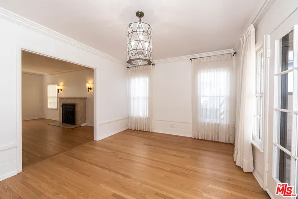 a view of a livingroom with wooden floor and a large window