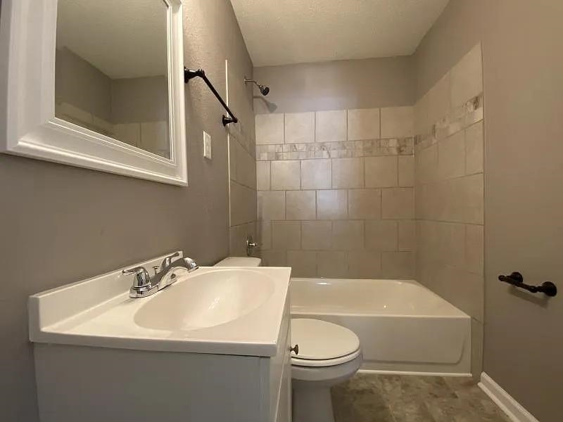 247 Modder Avenue Memphis, TN 38109 - Photo 7 of 9 a bathroom with a sink a toilet and shower