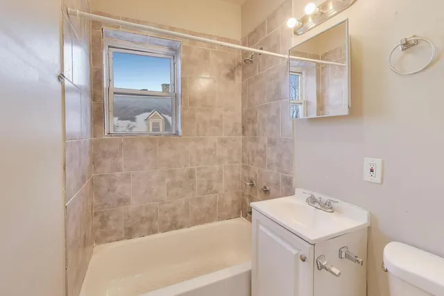 a bathroom with a sink a mirror and a bathtub