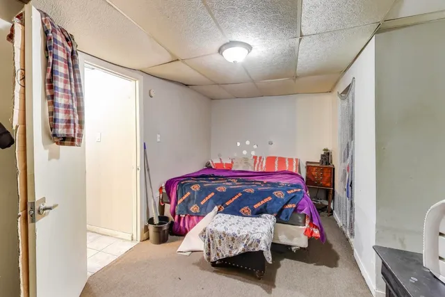 a bedroom with a bed and a mirror