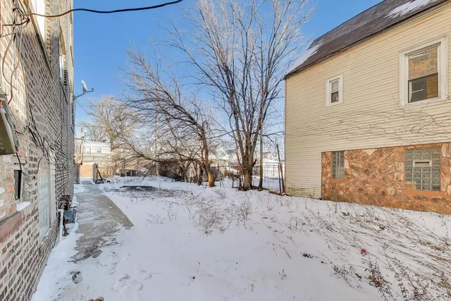 a view of a house with snow on the road