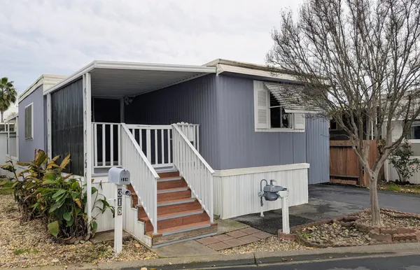 a view of a house with a deck front of house