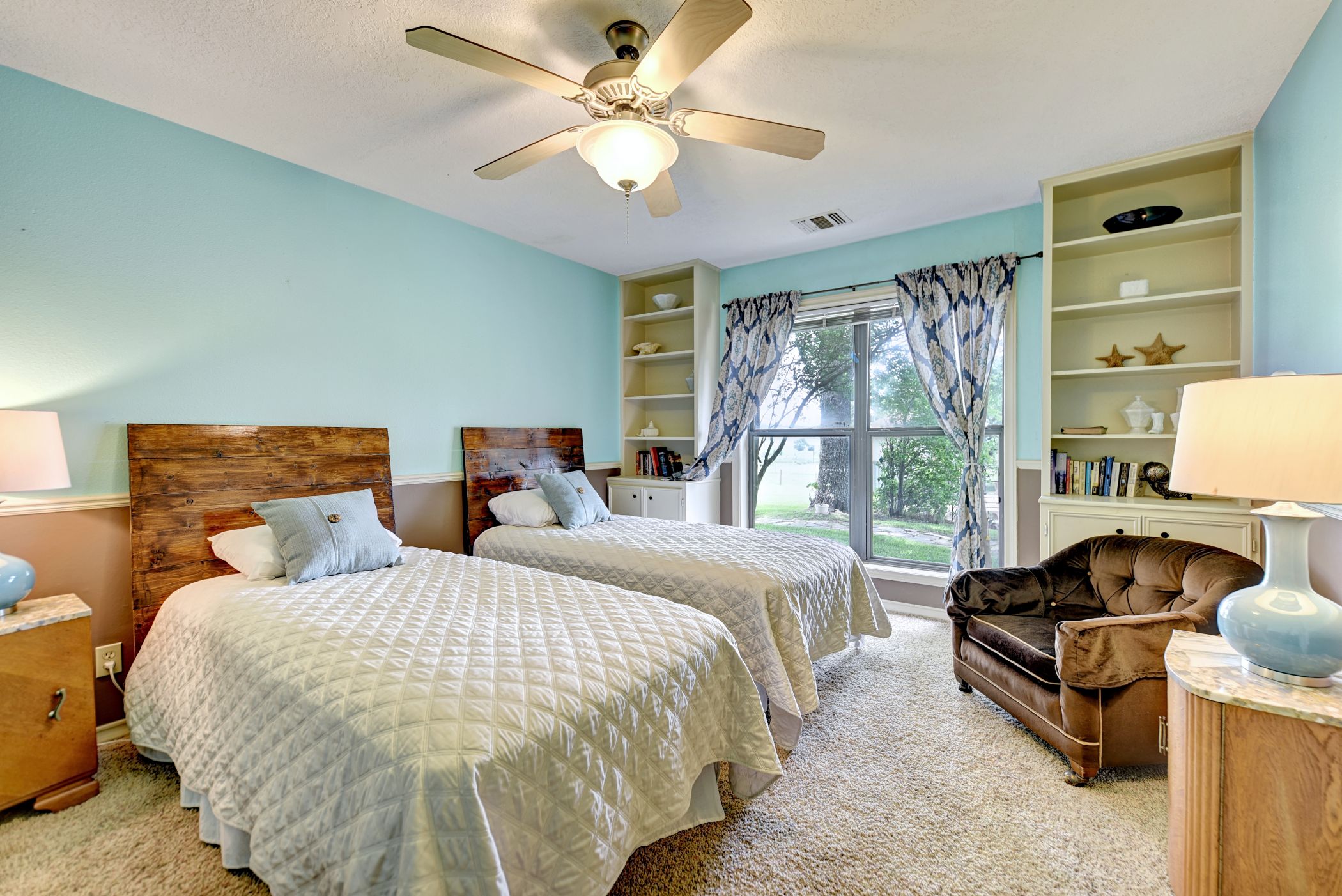 2575 Old Mill Creek Road Brenham, TX 77833 - Photo 11 of 40 a spacious bedroom with two beds and a large window
