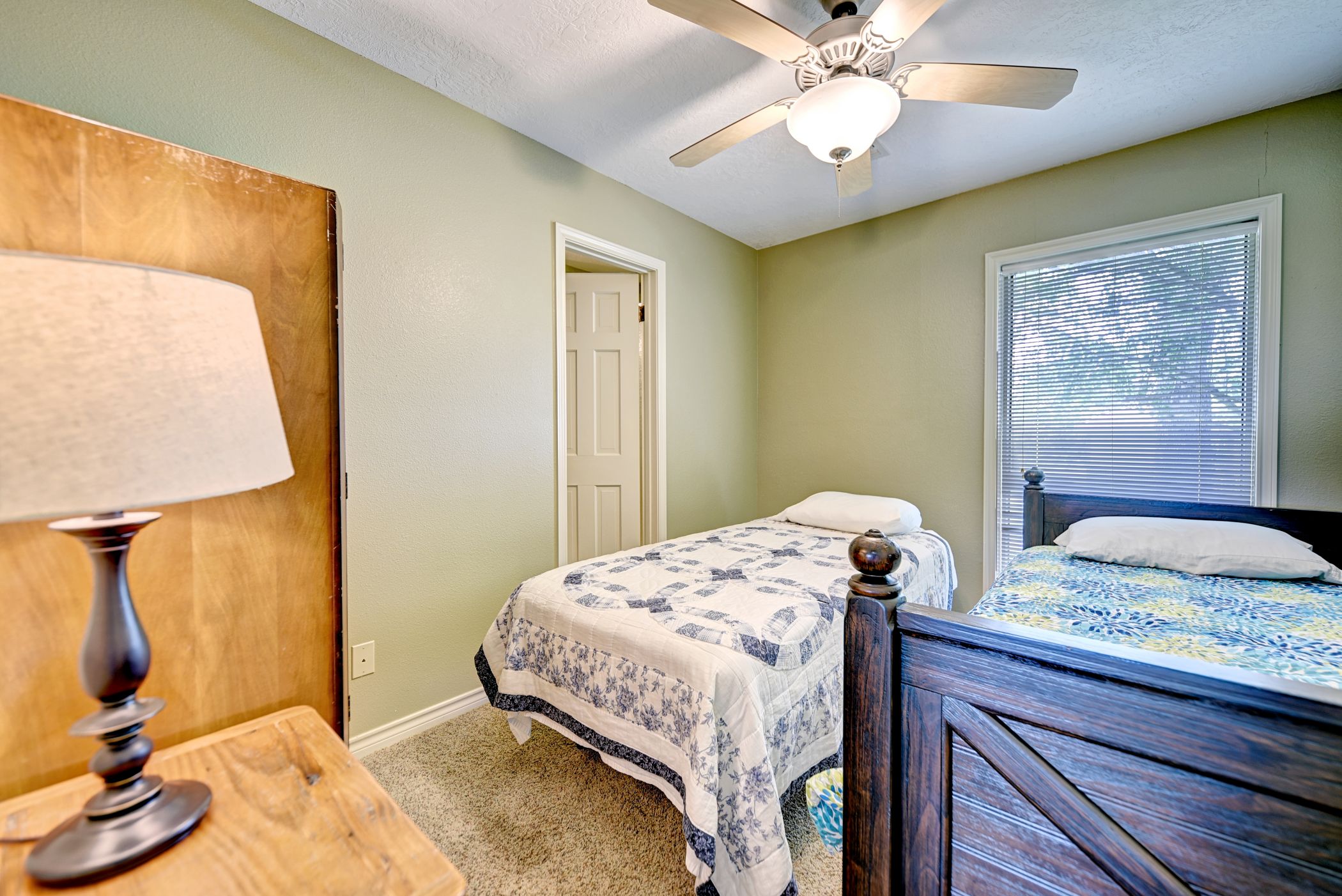2575 Old Mill Creek Road Brenham, TX 77833 - Photo 12 of 40 a bedroom with a bed and a chandelier
