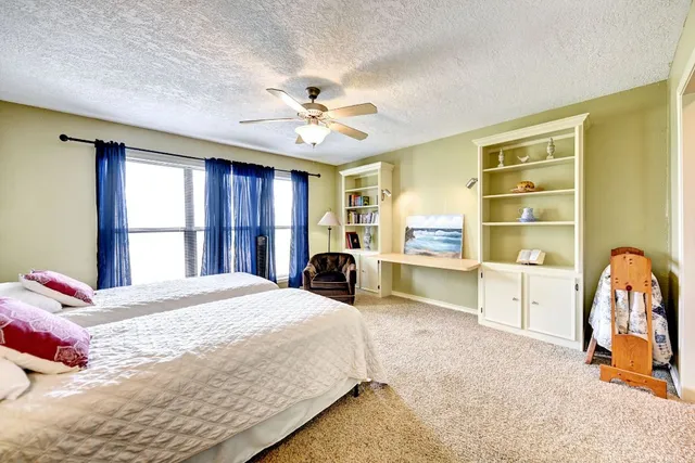 a bedroom with a large bed and a chandelier