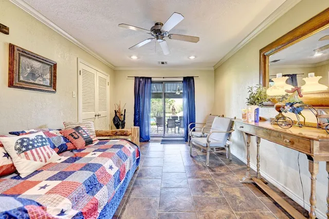 a spacious bedroom with a large bed and a chandelier