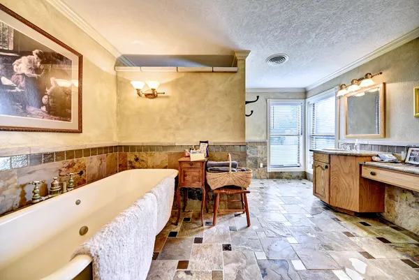a large living room with stainless steel appliances kitchen island granite countertop furniture and a large window