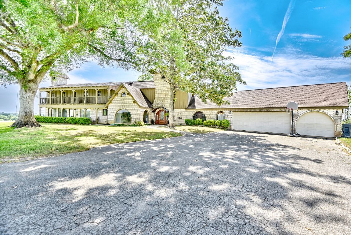 2575 Old Mill Creek Road Brenham, TX 77833 - Photo 2 of 40 a view of a house with a yard and garage
